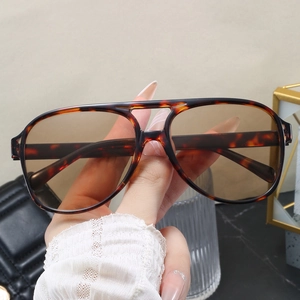 Close-up of retro aviator sunglasses with tortoiseshell frames and brown lenses
