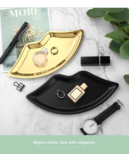 Lip-shaped stainless steel jewelry trays in gold mirror and black matte finishes