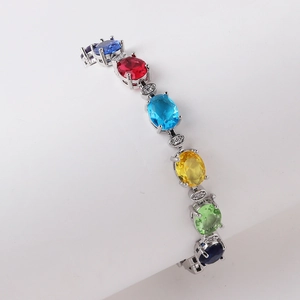 Macro detail of rainbow zircon bracelet with oval-cut multi-color stones in silver setting