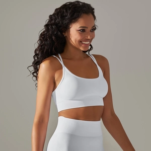 Close-up of white seamless sports bra with cross-back straps and ribbed hem support