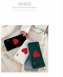 Detailed close-up of three Ace of Hearts canvas wallets in black, white, and dark green