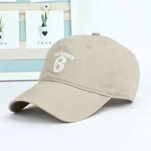 Khaki cotton baseball cap with white THE NUMBER 6 embroidery in a stylish 45-degree view