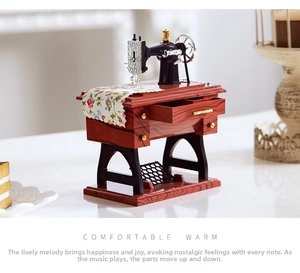 Detailed close-up of a vintage sewing machine music box with intricate moving parts