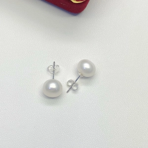 Detailed view of 925 silver butterfly backs and white freshwater pearl stud earrings