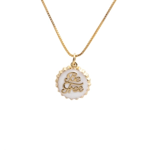 Gold plated 18K necklace with a white bottle cap pendant featuring Be Free text