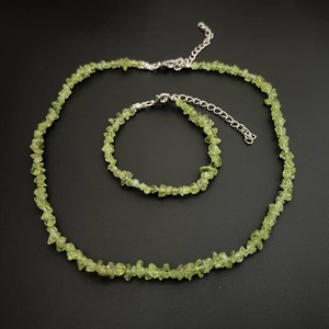 Detail of green peridot natural stone necklace and bracelet set with silver clasps