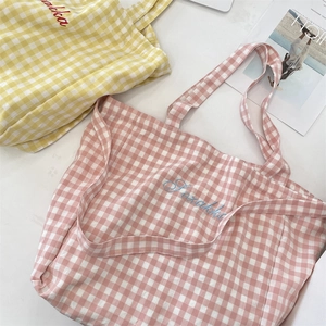 Detail of pink and yellow plaid tote bags with embroidery and large capacity
