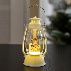 Close-up of a white Christmas lantern with snowman graphics and warm LED light decoration