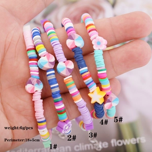 Detail of colorful Bohemian clay bracelets with star and heart charms for women