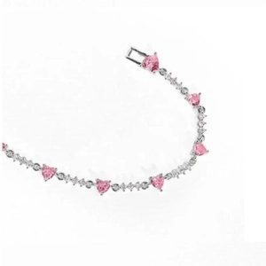Detail of pink heart zircon bracelet with silver chain and classic lobster clasp closure