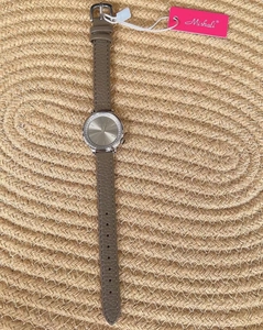Detail of Mishali women's watch featuring a diamond bezel and grey leather strap