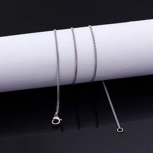 Silver stainless steel curb chain necklace with a lobster clasp on a display stand