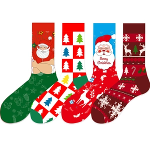 Detail of four Christmas crew socks featuring Santa, reindeer, and festive geometric patterns