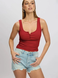 Detail of red slim fit ribbed tank top with buttoned henley neck and textured fabric