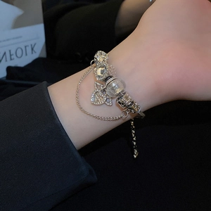 Elegant silver snake chain bracelet with heart-shaped rhinestone charm and beaded accents
