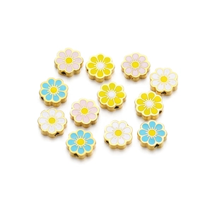 Detailed macro view of colorful enamel flower beads for DIY jewelry with gold metal edges