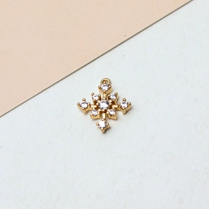 Detail-Makroaufnahme des Gold-Schneeflocken-Anhängers mit weißen Zirkonia-Steinen