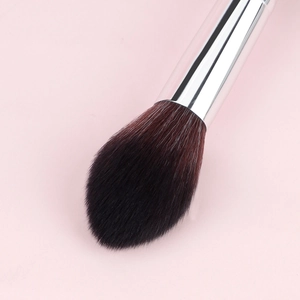 Detail of soft flame-shaped fiber bristles and silver metal ferrule for makeup brush