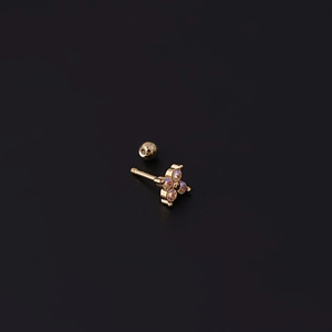 Macro shot of gold titanium steel ear stud with colorful gemstone flower and screw back