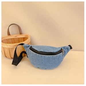 Detailed view of kids denim waist bag in blue with black zipper and woven strap details