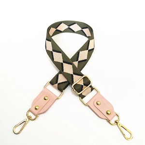 Close-up of ethnic jacquard bag strap in army green with pink leather and gold hardware