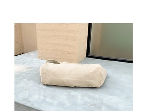 Detailed base of beige corduroy tote bag showing fine ribbed texture and sturdy rectangular shape
