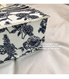 Detailed close-up of a blue floral Toile de Jouy pattern tote bag with woven texture
