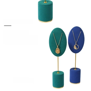 Detailed luxury velvet jewelry display stands in teal and navy with gold metal accents