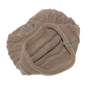 Close-up of brown chunky knit beanie with textured cable pattern on white background