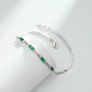 Detail of S925 sterling silver bracelet featuring square emerald green zircons and lobster clasp
