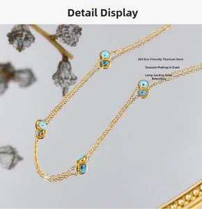 Macro detail of 304 stainless steel chain with blue evil eye beads and vacuum plating