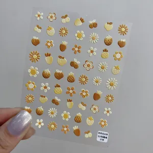 Macro shot of 5D embossed milk tea fruit nail stickers with daisies and strawberries