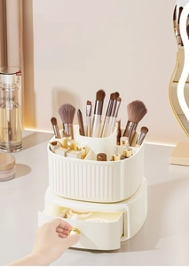 Close-up of a double-layer rotating makeup organizer with gold handles and divided slots
