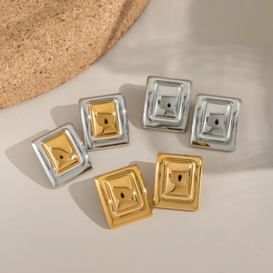 Close-up of square stainless steel earrings with vacuum-plated 18K gold and silver finish