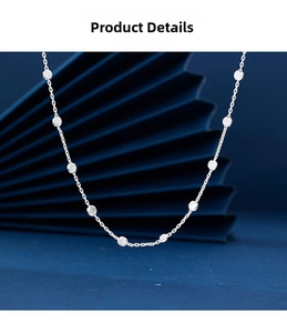 Macro shot of 925 silver necklace featuring textured circular beads on a fine chain link