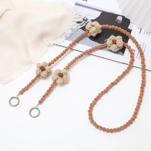 Close-up of winter plush beaded phone strap with crochet wool flowers and metal buckles