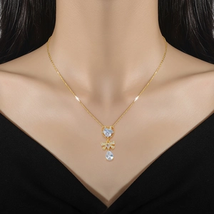 Luxurious gold butterfly teardrop necklace with shimmering crystals on a female model