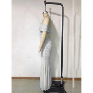 Side view of silver off-shoulder evening dress with pleated details and mermaid hemline