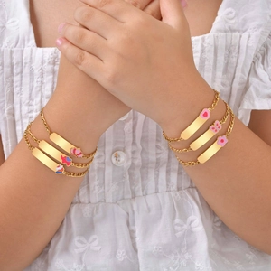 Kids gold stainless steel charm bracelet with colorful enamel pendants on wrist
