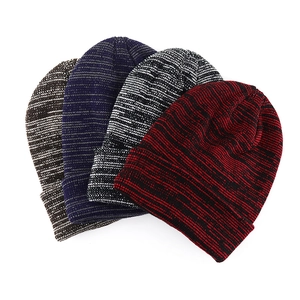 Detailed view of four striped knit beanies in brown, blue, black, and red colors