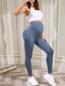 Detail of blue maternity yoga pants featuring honeycomb mesh texture for breathability