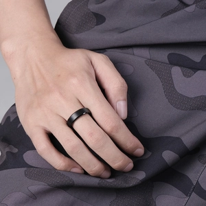 Minimalist matte black tungsten steel ring shown on a finger with industrial style