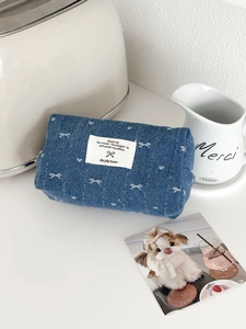 Denim bow storage pouch with butterfly embroidery and stylish label for cosmetics
