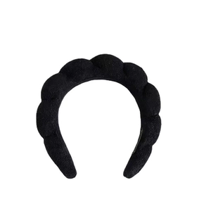 Detail shot of the black cloud sponge headband showing its soft knit fabric and wavy texture