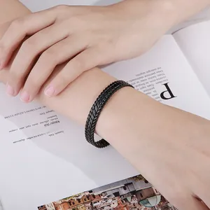 Detailed view of a 9mm black braided texture stainless steel cuff bangle on wrist