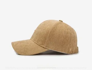 Detailed side view of khaki herringbone corduroy baseball cap with textured finish
