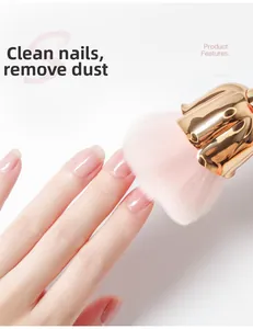 Detail of rose-shaped nail dust brush with soft pink bristles and gold plated base