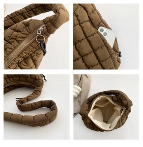 Detail view of brown quilted bubble bag showing zipper closure and internal storage pocket