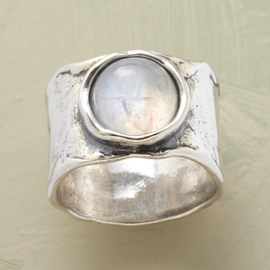 Macro shot of moonstone ring showing handmade hammered metal texture and blue shimmer