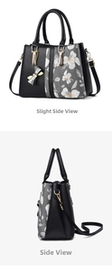 Detail view of floral print panel on black leather handbag with golden bow charm